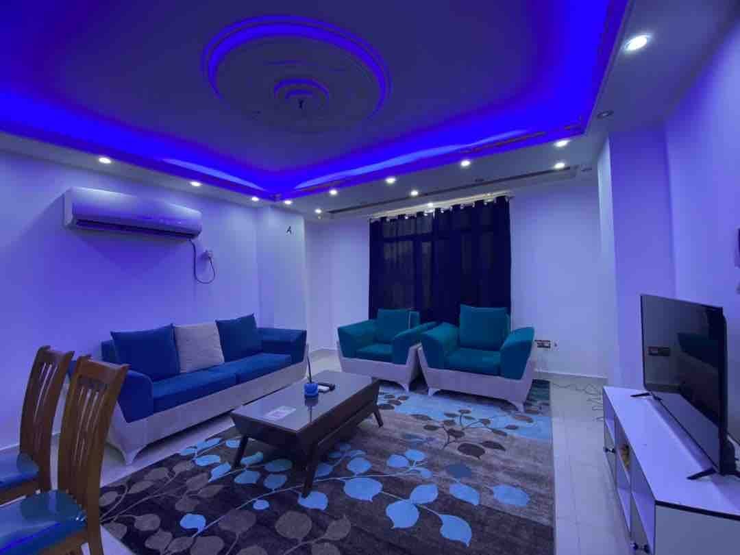 نشیمن لوکس با نورپردازی LED آبی و مبلمان فیروزه‌ای در آپارتمان سام پلاس قشم