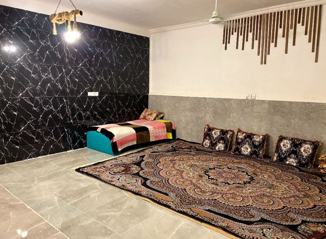 اتاق نشیمن با فرش و فضای پذیرایی در ویلا سه‌خوابه حسین هرمز
