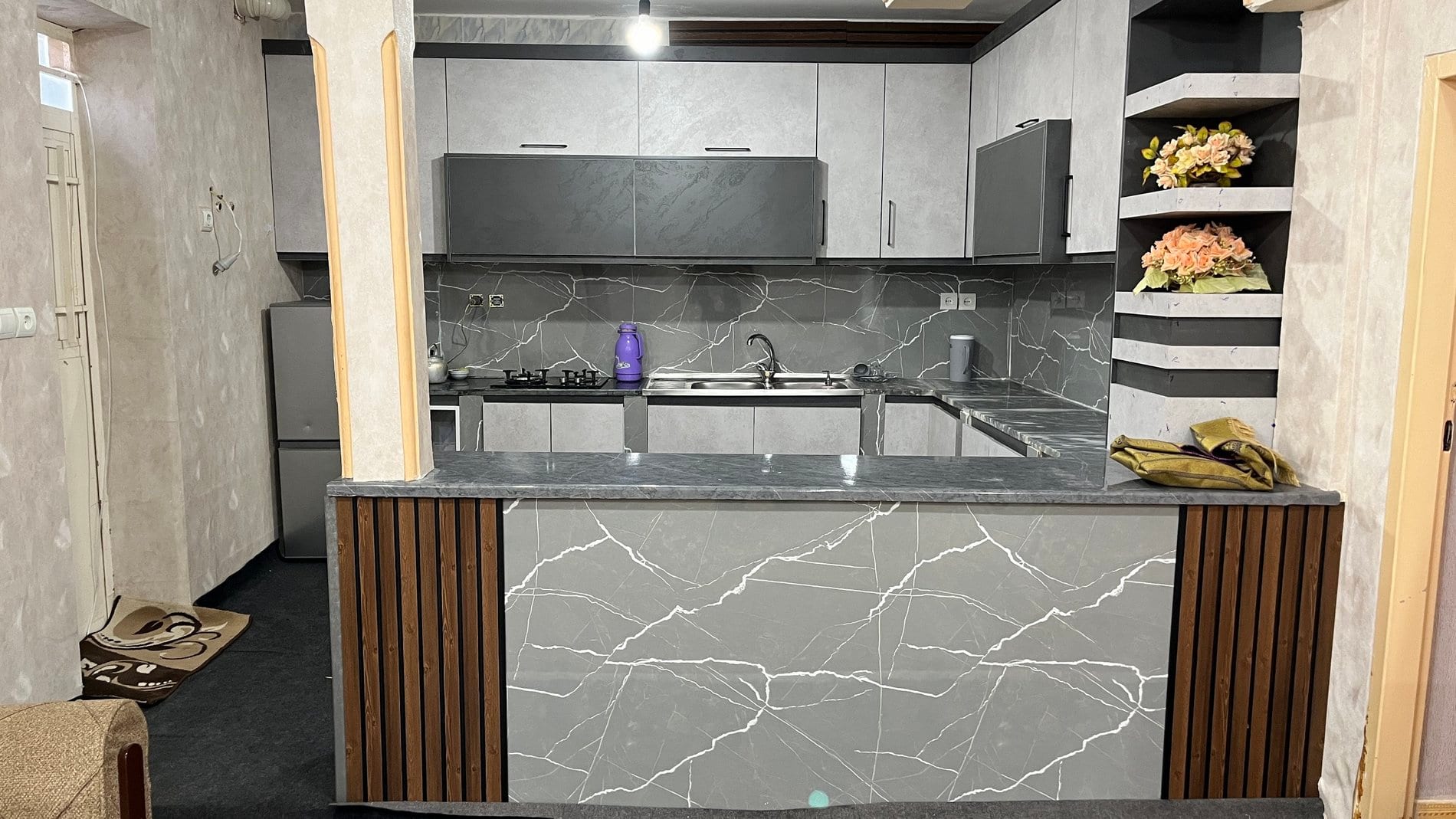 آشپزخانه با کابینت سفید و کانتر تیره در آپارتمان قشم